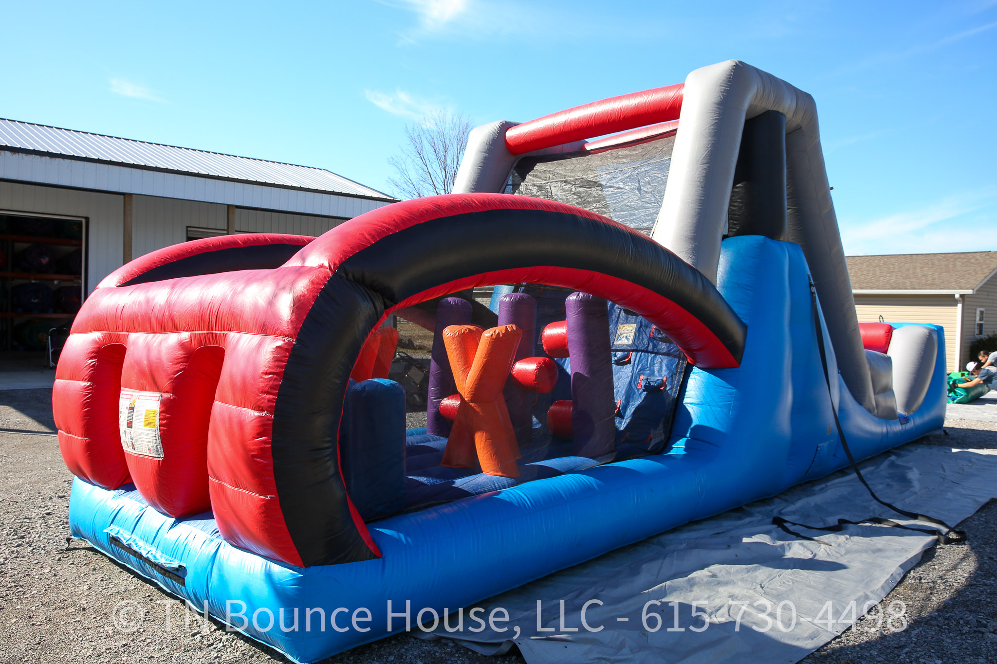 Inflatable obstacle course with water